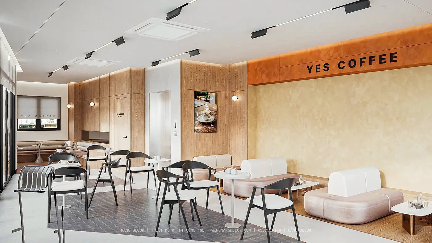 Không gian nội thất quán cafe hiện đại với ánh sáng tự nhiên và cây xanh.